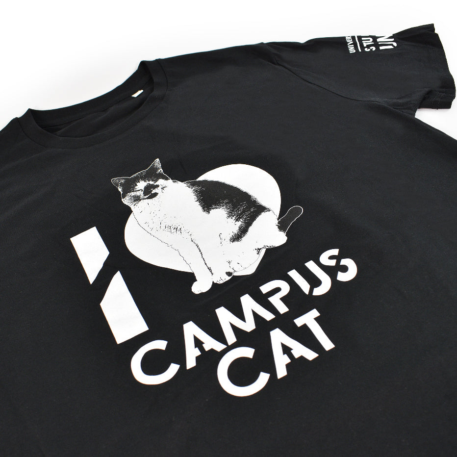 A black t-shirt with the words "I [love heart] Campus Cat" on the front and a picture of a black and white cat printed on it, close-up on the design