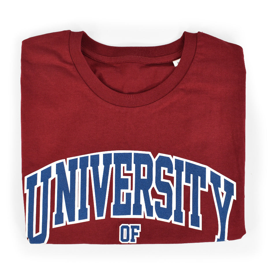 Burgundy Organic T-Shirt folded up to show "University" printed on the front in varsity style font 